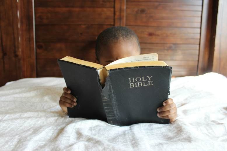 child reading a bible