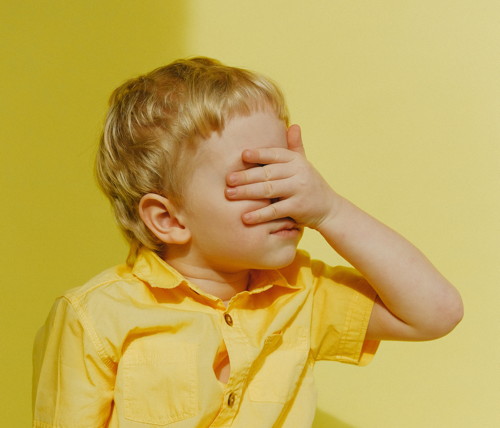 child covering his eyes